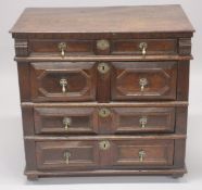 AN 18TH CENTURY OAK CHEST OF DRAWERS comprising four long drawers, each with geometric mouldings, on