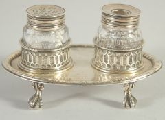 A GOOD EARLY GEORGE III TWO BOTTLED INKSTAND with pierced bottle holders, supported on four claw and