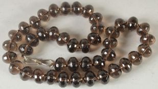 A SMOKEY QUARTZ NECKLACE. 18ins long.