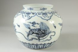 A CHINESE BLUE AND WHITE PORCELAIN JAR decorated with mythical beasts. 20cm high.