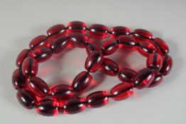 A STRING OF LARGE COLOURED BEADS. 36ins long.