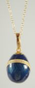A FABERGE FOUNDATION ENAMEL AND CRYSTAL DECORATED SILVER EGG PENDANT AND CHAIN.