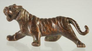 A SMALL JAPANESE BRONZE TIGER. 3ins long.