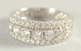 AN 18CT WHITE GOLD, DIAMOND HALF HOOP RING.