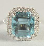 A VERY GOOD 18CT WHITE GOLD AQUAMARINE AND DIAMOND RING, the aquamarine of approx. 10 carats.