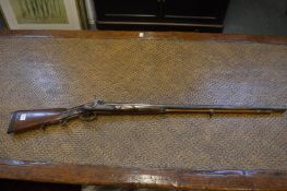 A DOUBLE BARREL GERMAN PERCUSSION SPORTING GUN, 16 bore with carved stock.
