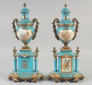 A PAIR OF SEVRES STYLE LIGHT BLUE PORCELAIN AND ORMOLU TWO HANDLED URNS AND COVERS on stands,
