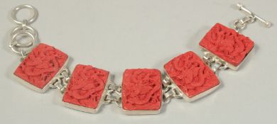 A SILVER AND CINNABAR BRACELET.