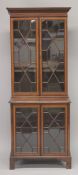 AN EDWARDIAN MAHOGANY INLAID STANDING CHINA CABINET with a pair of glazed astragal doors top and