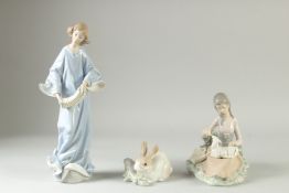 THREE LLADRO PORCELAIN GROUPS:A girl feeding a lamb, a rabbit, and a girl with a squeeze box. (3).