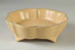 A CRACKLE GLAZE PETAL FORM BOWL raised on four feet. 19.5CM wide.