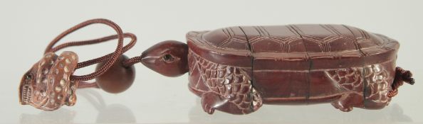 A CARVED WOOD TURTLE INRO AND ROPE.