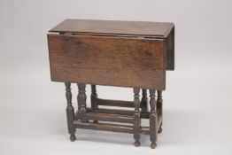 AN 18TH CENTURY OAK DROP FLAP TABLE with end drawer, turned legs with gate leg action and plain