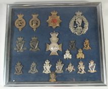 A FRAMED COLLECTION OF 19 SILVER AND BRONZE BADGES, COUNTY LOUTH RIFLES, ROYAL IRISH RIFLES, ROYAL