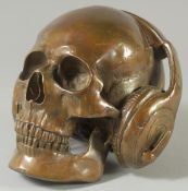 A BRONZE SKULL with headphones.