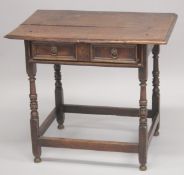 AN 18TH CENTURY OAK SIDE TABLE with plank top, long freize drawer with brass handles, on turned legs