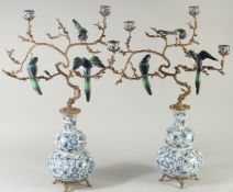 A GOOD PAIR OF LARGE BLUE AND WHITE PORCELAIN GROUP BIRD CANDELABRA the metal branches with three