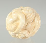 A CARVED BONE EROTIC BALL. 3.5cm.