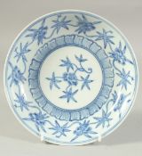 A CHINESE BLUE AND WHITE PORCELAIN DISH, decorated with flora. 21cm diameter.