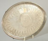 A GEORGE III ENGRAVED OVAL SILVER SALVER on four curving legs. 9.5ins long. London 1809. Maker, JOHN