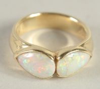 A 9 CARAT GOLD TWO STONE OPAL RING.