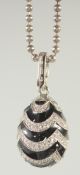 A FABERGE FOUNDATION ENAMEL AND CRYSTAL DECORATED SILVER EGG PENDANT AND CHAIN.