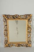 A GOOD 19TH CENTURY ITALIAN CARVED GILTWOOD MIRROR. 19ins x 16ins.