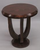 AN ART DECO STYLE ROSEWOOD CIRCULAR TABLE on curving supports. 2ft high x 1ft 9ins diameter.