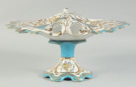 A SEVRES STYLE BLUE, WHITE AND GILT COMPORT painted with vignettes of musical instruments. 1ft