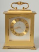 A HEAVY BRASS CLOCK by LOOPING with quartz movement and carrying handles. 9ins high.
