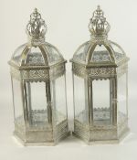 A PAIR OF SILVERED METAL OCTAGONAL LANTERNS with glass panel and crown. 24ins high.