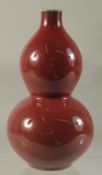 A CHINESE PORCELAIN RED DOUBLE GOURD VASE. 7.5ins high.