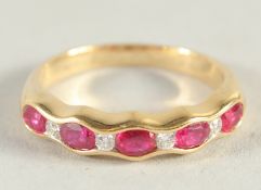 AN 18CT YELLOW GOLD, RUBY AND DIAMOND HALF HOOP RING.