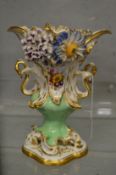 A LARGE FLOWER ENCRUSTED URN SHAPED VASE.