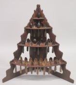 AN UNUSUAL 19TH CENTURY PINE CORNER SPOON RACK, comprising three tiers, each holding numerous carved