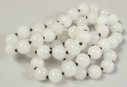 A STRING OF SIXTY WHITE BEADS.