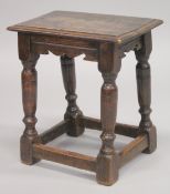 AN 18TH CENTURY OAK JOINT STOOL, with rectangular top, turned leg and a plain uniting stretchers.