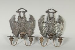A PAIR OF TWO BRANCH BRONZE BATS WALL LIGHTS with sconces.