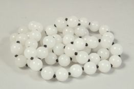 A STRING OF SIXTY WHITE BEADS. 26ins long.
