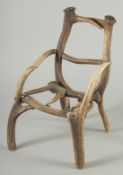 AN UNUSUAL MINIATURE DEER ANTLER ARMCHAIR.. 1ft 4ins high x 1ft wide.