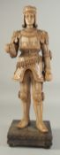 A GOOD LIMEWOOD CARVING OF A MID 15TH CENTURY NOBLEMAN, wearing armour, from the solid, on a