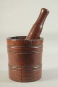 A GOOD EARLY 18TH CENTURY WOODEN PESTLE AND MORTAR. 8ins high x 7ins diameter.
