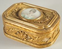 A GOOD FRENCH PALAIS ROYAL GILT BOX AND COVER the top inset with a circular miniature of a lady.