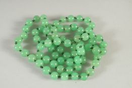 A GOOD STRING OF EIGHTY SMALL BEADS. 28ins long.