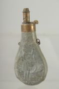 A GOOD SMALL COPPER POWDER FLASK repousse with a man holding a rabbit. 6ins long dinted.