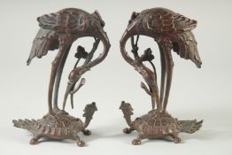 A GOOD PAIR OF BRONZE STORKS STANDING ON A TURTLE. 7ins hgih.