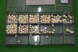 A box of loose pearls.