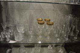 A set of gilt decorated cut glass wine glasses and other glassware.