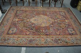 A large Persian style rug with all over floral decoration 285cm x 210cm.