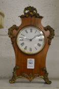 A small mantel clock.